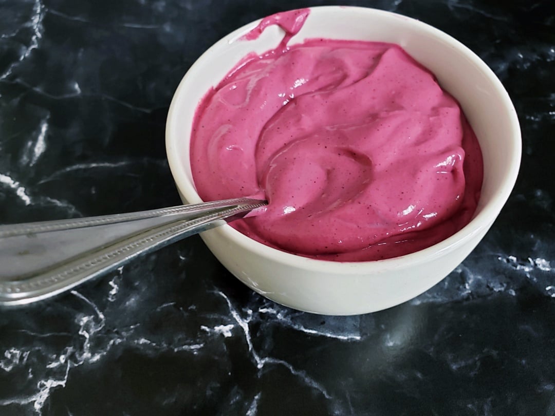 Berry Cashew Crème in a bowl + spoon