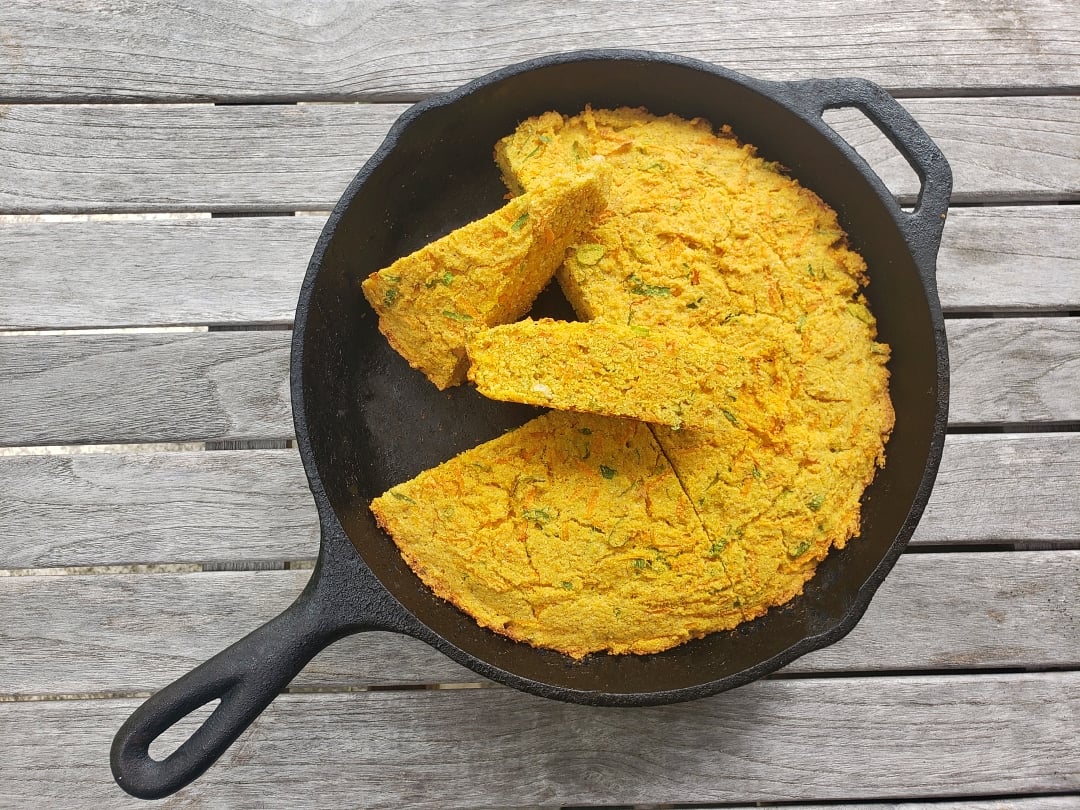 Carrot Cornbread in a cast iron skillet 
