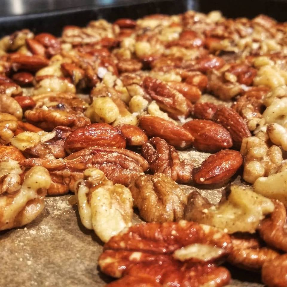 Cider Maple Spiced Roasted Nuts on parchment lined sheet pan