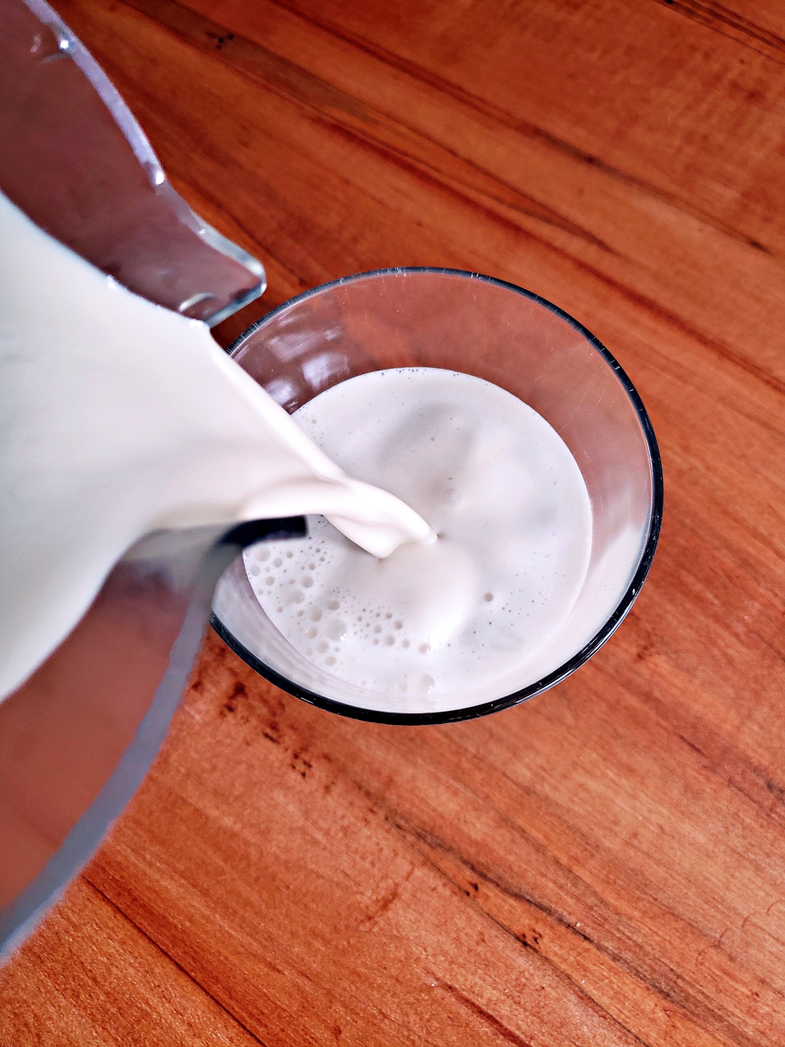 Pouring cashew milk into a glass
