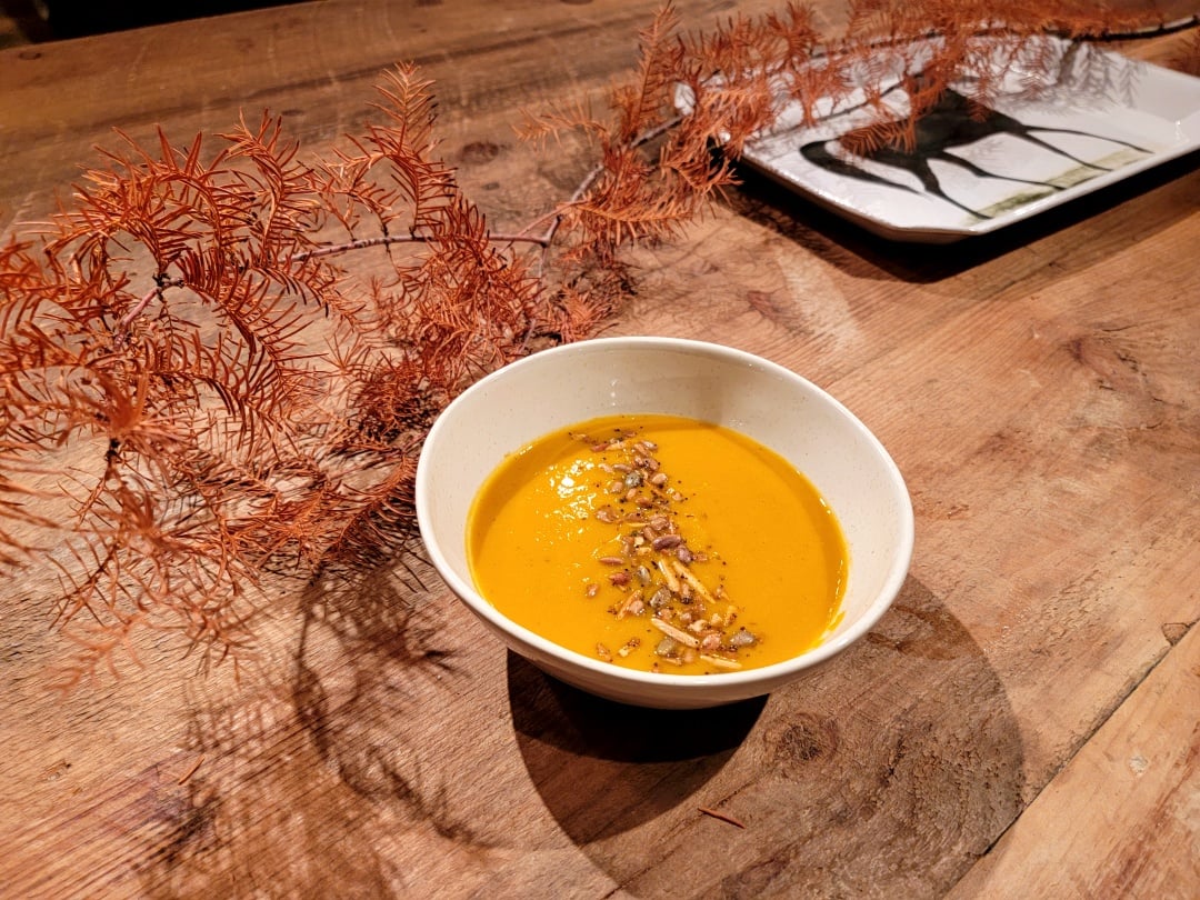 Roast Squash & Chickpea Soup in a bowl w/ herb roastes almonds & pumpkin seeds
