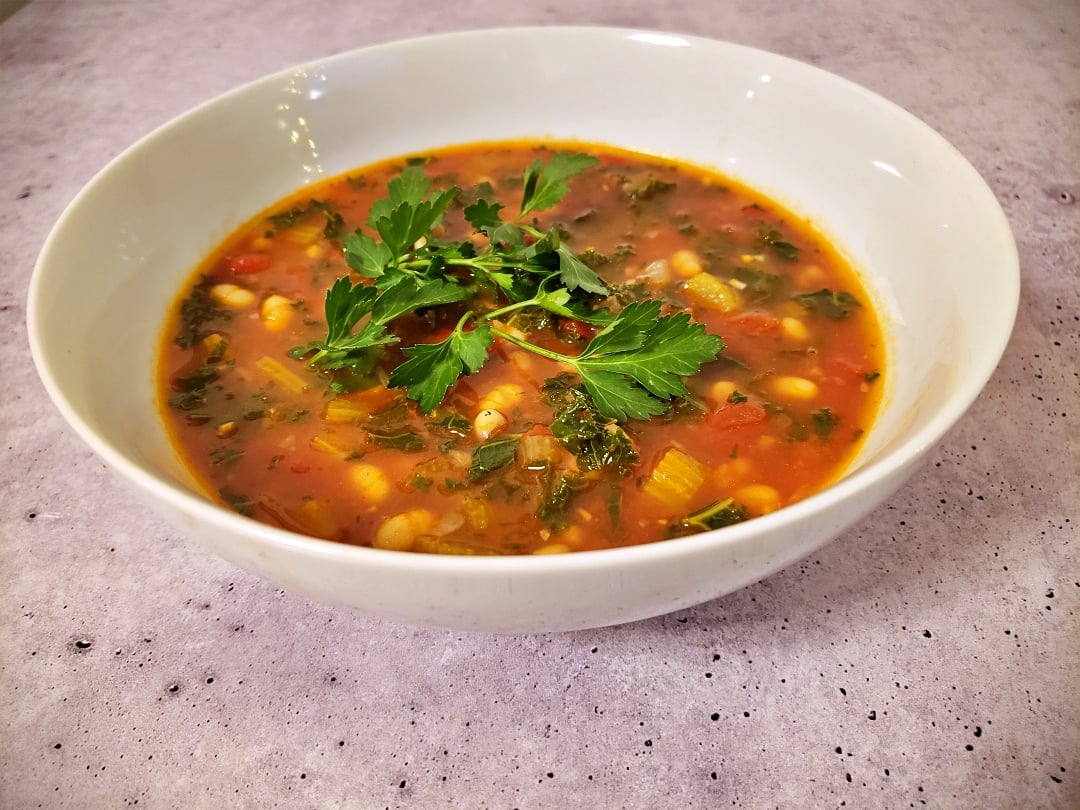 Tuscan White Bean Soup bowl + parsley garnish