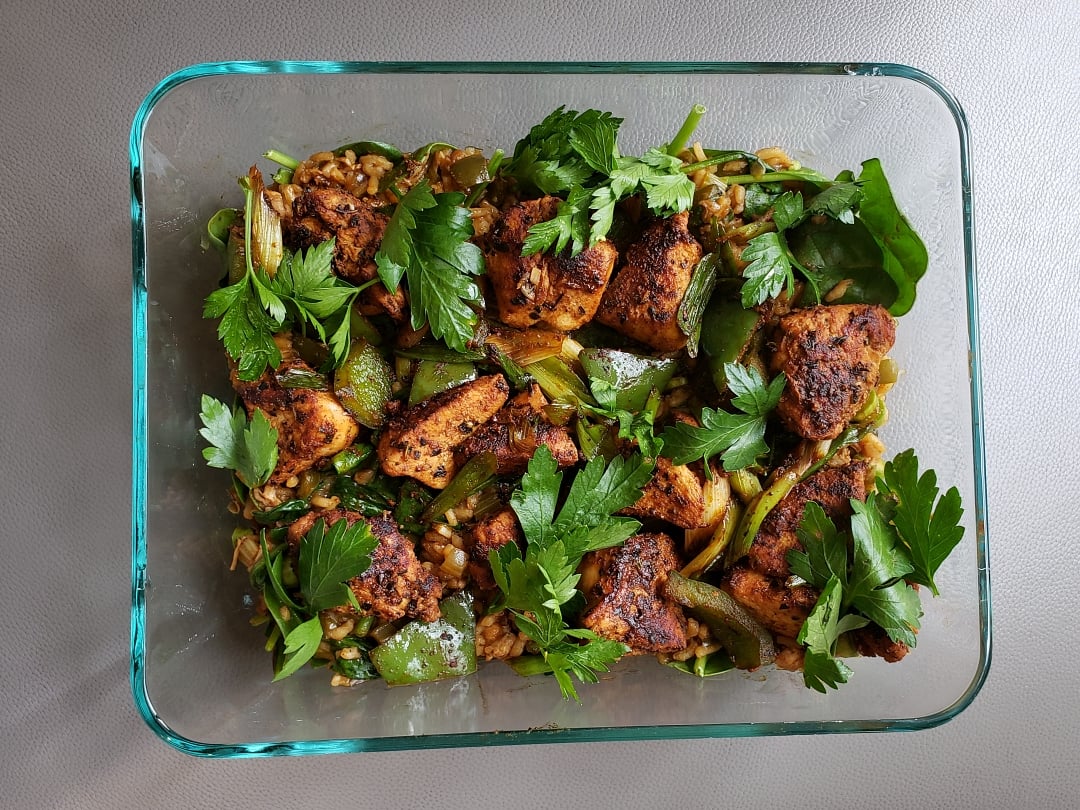 recipe in glass dish with parsley leaves on top