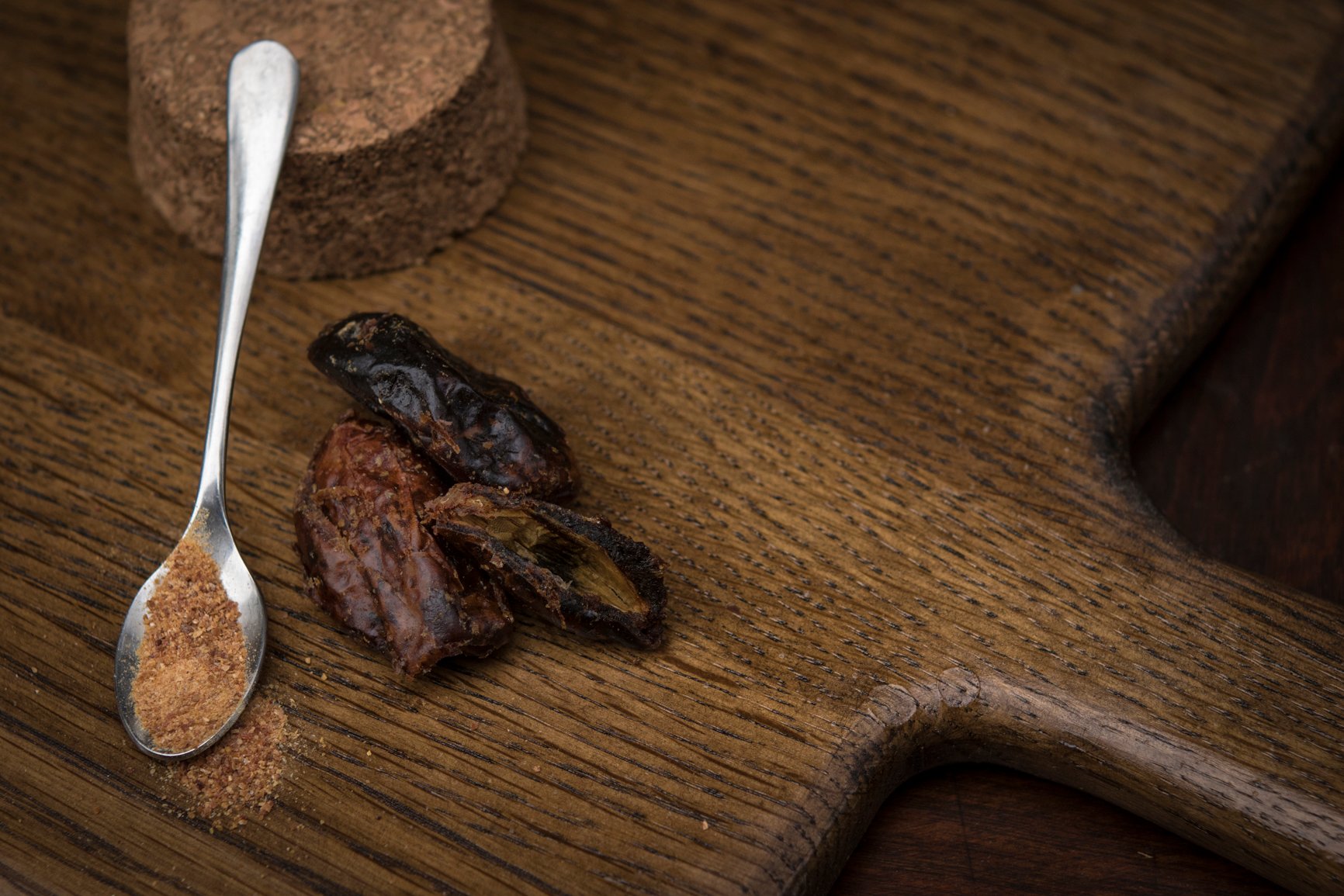 dried dates and date sugar on a teaspoon